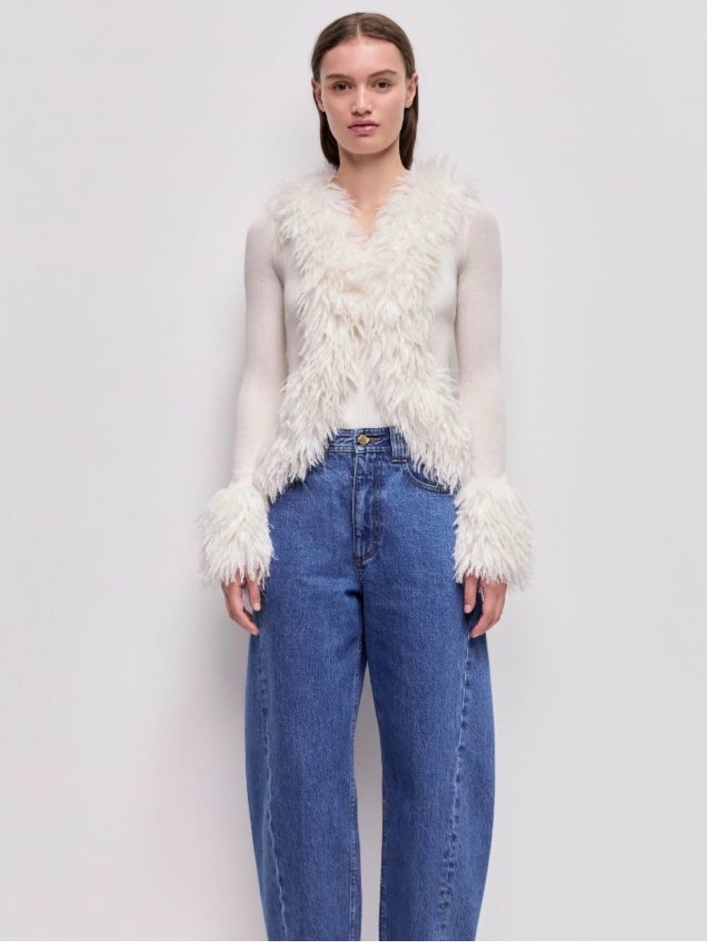 Aje Cream Faux Fur-Trim Knit Top with Blue Jeans
